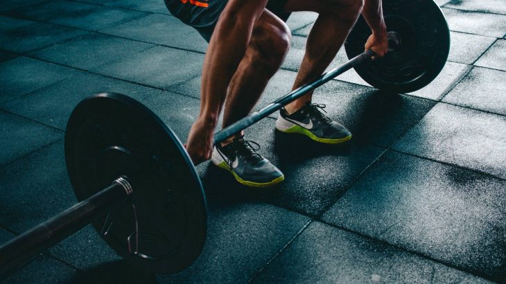 person holding barbell